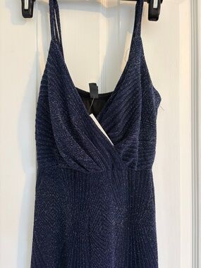 Francescas dark blue jumpsuit with a shimmering finish.